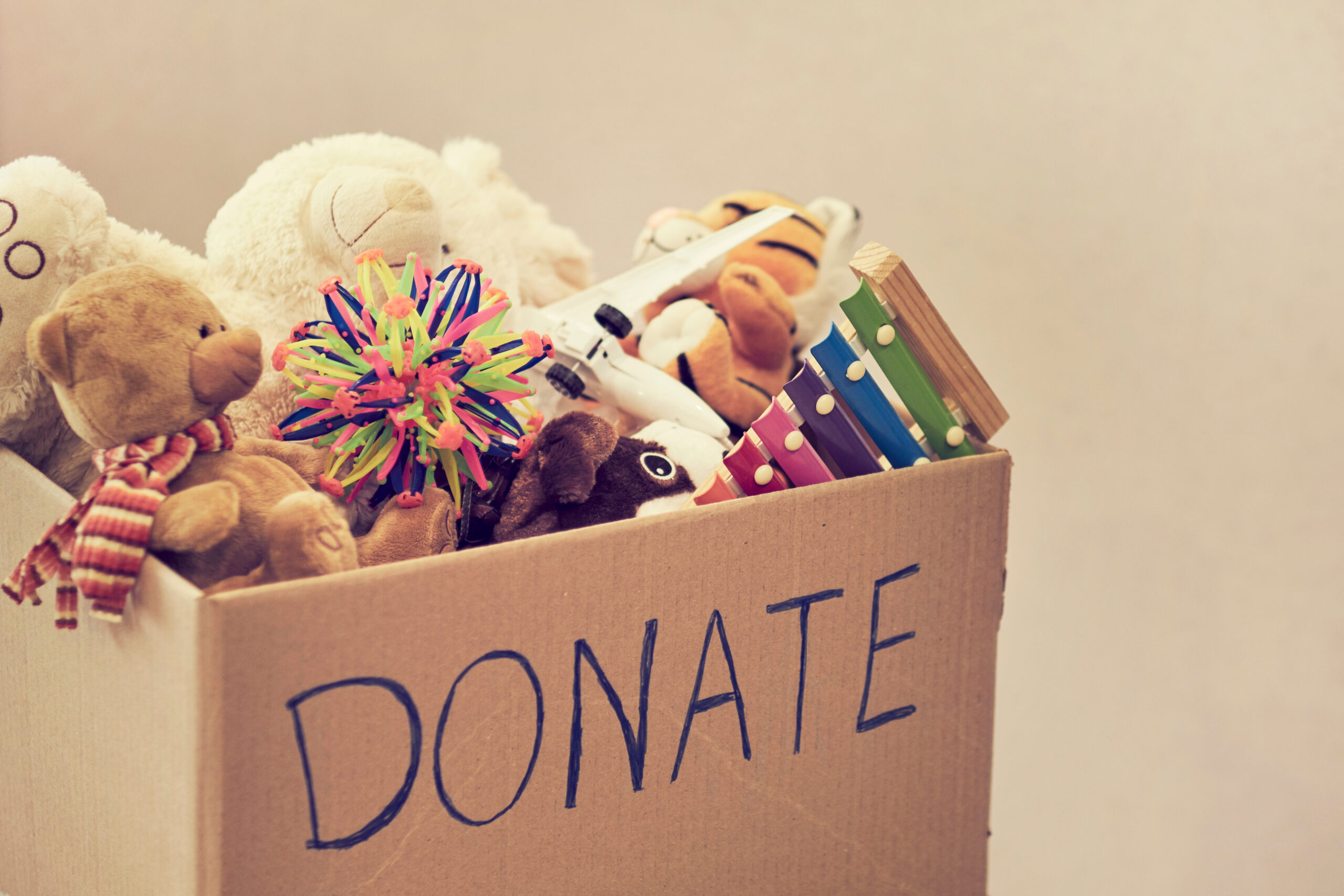 Toys in a box that says donate.